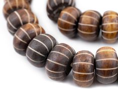 the beads are brown and white with stripes on them