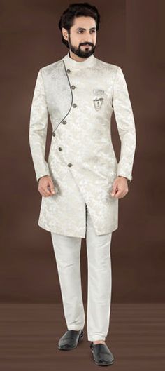 Silver color IndoWestern Dress in Jacquard fabric with Embroidered, Resham, Sequence, Thread work Elegant White Kurta With Floral Embroidery, Elegant Jacquard Kurta For Festive Occasions, Festive Jacquard Kurta For Wedding, White Fitted Elegant Kurta, White Festive Ceremony Dress, Festive White Ceremony Dress, Traditional White Brocade Kurta, White Brocade Kurta For Wedding, White Brocade Sherwani For Festive Occasions