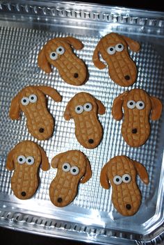 cookies shaped like dogs with googly eyes on a pan