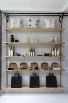 the shelves are filled with purses and other items