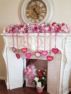 valentine's day decorations in front of a fireplace with a clock on the wall