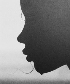 the silhouette of a woman's head is shown in black and white