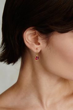 An elegant way to wear your birthstone. Faceted ruby crystals sparkle in these timeless gold hoop earrings. 18k gold plated sterling silver. 1" drop. Handmade in Vietnam. Ruby Hoop Earrings, Yellow Gold Huggie Earrings With Birthstone For Gift, Elegant Gold Huggie Earrings With Birthstone, Gold Ruby Drop Earrings, Gold Huggie Earrings With Birthstone For Fine Jewelry, Gold Birthstone Huggie Earrings Fine Jewelry, Gold Huggie Earrings With Birthstone, Gold Hoop Earrings With Birthstone, Gold Hoop Earrings With Birthstone - Fine Jewelry