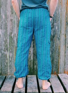 "Our Inca pants are a cultural experience and travelers' favorite. These lounge pants are comfortable, lightweight, stylish, fresh, and relaxing. With banded waist and drawstrings in the waist and legs, they could be adjusted to fit your style and comfort. Whether they are used as Capri or Flat pants style, Inca pants are perfect for any weather conditions and for any occasion. They look great on Men or Women of any age. - Banded waist/Drawstrings in waist and leg - Four pockets, 2 front and 2 s Casual Harem Yoga Pants, Casual Cotton Parachute Pants For Beach, Casual Cotton Harem Cargo Pants, Blue Casual Harem Pants With Pockets, Casual Blue Harem Pants With Pockets, Casual Harem Yoga Pants With Pockets, Casual Yoga Parachute Pants With Elastic Waistband, Casual Parachute Pants With Elastic Waistband For Yoga, Casual Yoga Parachute Pants