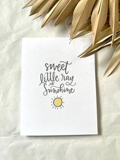 a piece of paper with the words sweet little ray and sunshine on it next to some leaves