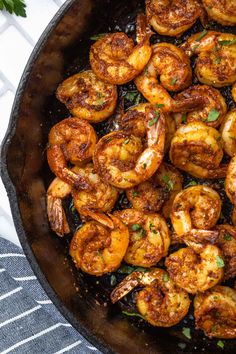 cooked shrimp in a skillet with parsley