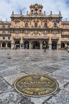 the entrance to an old building with a plaque on it's ground in front of it