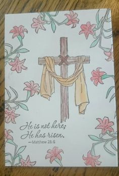 a card with a cross and flowers on it