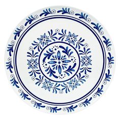 a blue and white plate with an ornate design in the center on a white background