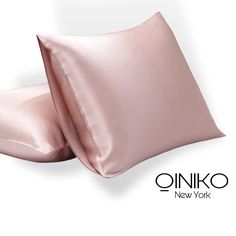 two pillows with satin sheets on them and the words oinko new york written in black