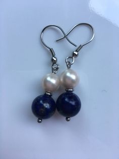 "Lapis lazuli gemstone earrings: A 10mm Lapis lazuli gemstone with 8mm ivory shell pearls, this earrings about 2\" long top to bottom, and it's made with stainless steel, Hypoallergenic. Hand made jewelry." Round Pearl Earrings, Woman Earrings, Gifts For Moms, Antique Filigree, Lapis Lazuli Gemstone, Jewelry Blue, For Her Gifts, Earrings Pearl, Hanging Pendants