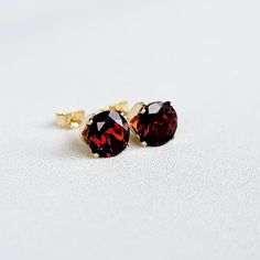 Sparkling red garnets are a must have for any girls collection. These beauties are available in your choice of a 14K gold-filled setting, 14k solid gold setting, or .925 silver setting. Both gold metals are tarnish resistant, water resistant, and hypoallergenic. These sophisticated gemstone earrings Classic Red Birthstone Jewelry, Classic Ruby Birthstone Earrings, Fine Jewelry Garnet Round Earrings, Garnet Fine Jewelry Earrings, Round Garnet Earrings Fine Jewelry, Red Round Cut Birthstone Earrings, Garnet Round Earrings For Anniversary, Garnet Earrings For Anniversary, Round Garnet Jewelry For Pierced Ears