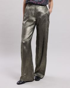 Women's wide, flowing lamé pants. High waist, flat belt with loops and zipper. Two Italian pockets on the sides. Elegant Metallic Pants For Party, Elegant Metallic Bottoms For Evening, Luxury Wide-leg Party Bottoms, Full Length Metallic Pants For Night Out, Metallic Shiny Bottoms For Evening, Elegant Metallic Bottoms For Party, Glamorous Gold Bottoms For Fall, Elegant Metallic Party Bottoms, Chic Shiny Pants For Fall