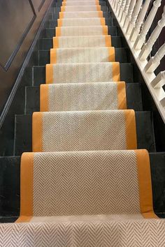 an escalator with yellow and white carpeting next to a set of stairs