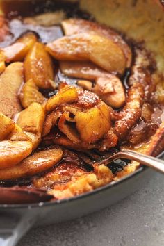 some food is cooking in a skillet on the stove top and ready to be eaten