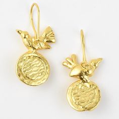 two gold earrings with birds on them