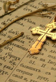 a cross is laying on top of an old book