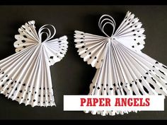 two paper angels made out of white paper with black dots on them and the words paper angels