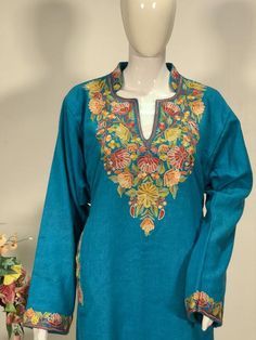 A stunningly marvellous Pheran. This Pheran features intricate Kashmir Aari embroidery on neckline and sleeves.- - - - - - - - - - - - - - - - - - - - Product Details- Condition: Brand New (made to order)- Style: Pheran Tunic with Half Band Collar- Fabric: Pure Wool- Colour: Turquoise- Embroidery: Aari Work- Embroidery Colour: Multi-Colour- Standard Length: 40" | Can be customized- Care Instructions: Dry Clean Only**If you want the Tunic to be shorter or longer, just send us a message, and we wi Pheran Kashmir Women, Half Band Neck Kurti, Traditional Multicolor Designer Kaftan, Traditional Designer Kaftan For Transitional Season, Traditional Chanderi Kaftan With Embroidered Border, Bohemian Semi-stitched Kaftan With Resham Embroidery, Bohemian Kaftan With Resham Embroidery Semi-stitched, Band Neck Designs For Kurtis, Resham Embroidered Kaftan For Festivals