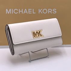 Brand New With Tag Michael Kors Large Mimi Bifold Wallet Color: Optic White Gold Tone Hardware Mk Signature Logo Pvc Coated Canvas Body And Saffiano Leather Inside. 8 Credit Card Holders 1 Large Slip Pocket Inside And 1 Large Slip Packet Outside Lzip Pocket Inside 7.5"L 1.75"W 3.80"H Luxury White Wallets With Card Slots, Classic White Wallets For Daily Use, Michael Kors Elegant Clutch Wallet, Classic White Bag With Card Slots, Classic White Wallets For Everyday Use, Elegant Michael Kors Clutch Wallet, Classic Everyday White Wallets, Classic White Wallet For Travel, White Bifold Wallet For Gift