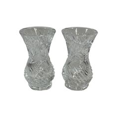 two clear glass vases sitting side by side on a white background with no one in the photo