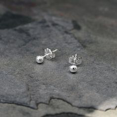 Solid Sterling Silver Studs I melted sterling silver into tiny round balls. The the balls are soldered on to sterling silver posts with floral western style earring backs. 3.5mm balls ~ perfect to wear alone or for second piercings. For more earrings: https://www.etsy.com/shop/KiraFerrer?section_id=7937255&ref=shopsection_leftnav_3 To see my entire collection: https://www.etsy.com/shop/KiraFerrer?ref=hdr_shop_menu Dainty Silver Earrings With Round Beads, Second Piercings, Second Piercing, Tiny Studs, Sterling Silver Stud Earrings, Tiny Stud Earrings, Silver Stud Earrings, Dainty Earrings, Sterling Silver Studs