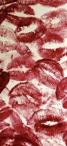 an abstract painting with red and white paint on it's surface, showing the texture of feathers