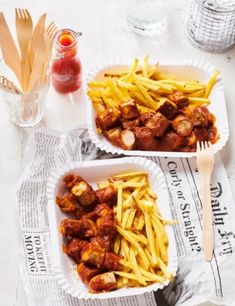 two plates filled with french fries and meatballs