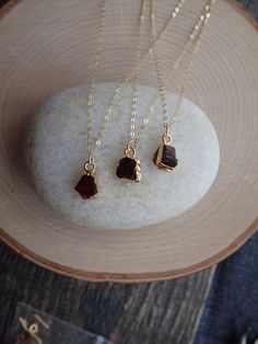 Beautiful and all-natural garnet gemstones electoplated in 14k gold and hung from a dainty an light-catching gold fill chain. Super sweet everyday necklace in genuine and alluring Garnet. This January Birthstone has been used by civilizations for eons who cherished it for it's deep red color and inner glow. A stone of love and friendship it is also the traditional gift given for 2nd year wedding anniversaries. In earlier times, garnets were exchanged as gifts between friends to demonstrate their 14k Gold Wire Wrapped Necklace For Gift, 14k Gold Wire Wrapped Necklace As Gift, Dainty Garnet Necklace For Gift, Gold Garnet Necklace For Gift, Gold Garnet Birthstone Necklace, Amber Birthstone Dainty Necklace, Dainty Gold Garnet Jewelry, Dainty Gold Necklace With Raw Stone, Gold Necklace With Raw Stone For Everyday