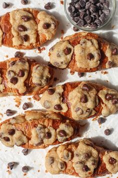 chocolate chip cookies are arranged on parchment paper