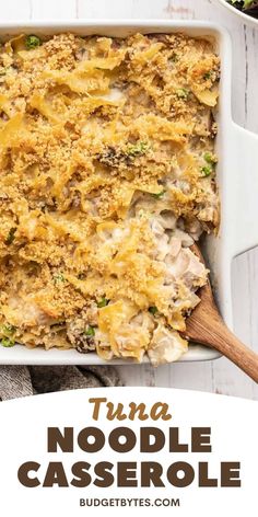 tuna noodle casserole in a white baking dish with a wooden spoon on the side