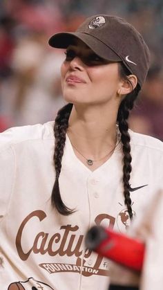 a female baseball player with braids on her hair