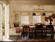 a living room filled with furniture and windows