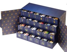 a set of twelve blue boxes with numbers on the front and bottom, each containing different items