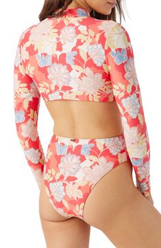 Tropical blooms brings vacation-ready style to this long-sleeve one-piece with sunny waist cutouts. Front zip closure Mock neck Long sleeves Moderate back coverage 85% recycled polyester, 15% elastane Hand wash, dry flat Imported lined Spring Long Sleeve Surfing Bodysuit, Long Sleeve Beachy Swimwear For Pool, Long Sleeve Tops For Pool And Spring, Beachy Long Sleeve Tops For Poolside, Long Sleeve Floral Print Swimwear For Surfing, Summer Long Sleeve Tops For Poolside, Fitted Long Sleeve Swimwear For Beach Season, Long Sleeve Summer Tops For Poolside, Spring Long Sleeve Tops For Poolside