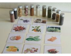 a table topped with lots of cards and jars filled with different types of spices on top of it