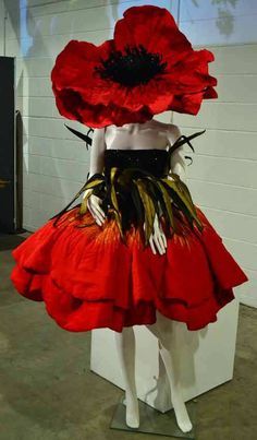 a mannequin dressed in red and black with large flowers