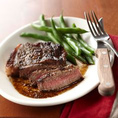 steak and green beans on a white plate