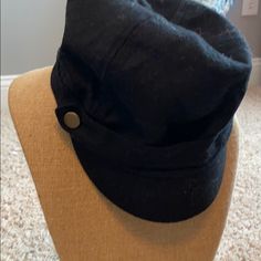 a close up of a black hat on a mannequin