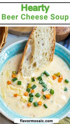 a bowl of hearty beer cheese soup with a piece of bread sticking out of it