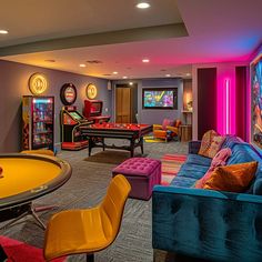 a brightly lit game room with pool tables and arcade gaming machines on the wall, as well as colorful couches