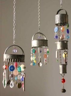 three wind chimes hanging from the ceiling with beads and chains attached to each other