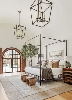 a bedroom with a four poster bed and wooden floors