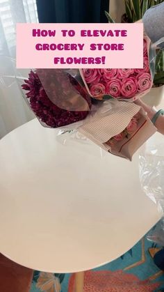 a white table topped with pink flowers on top of it