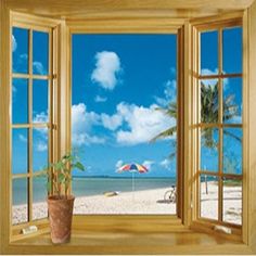 an open window showing the beach and palm trees from inside, with a view of the ocean