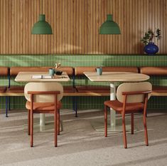 two wooden benches sitting next to each other in a room with green tile on the walls