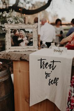 a sign that says treat to see on it next to a table with pictures and candles