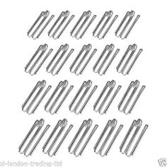 an assortment of metal clips on a white background