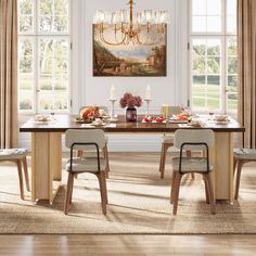 a dining room table with chairs and a chandelier hanging from the ceiling above it