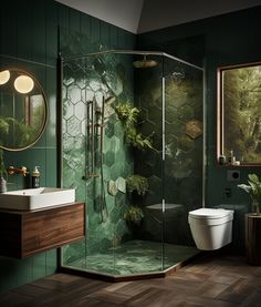 a bathroom with green walls and wood floors